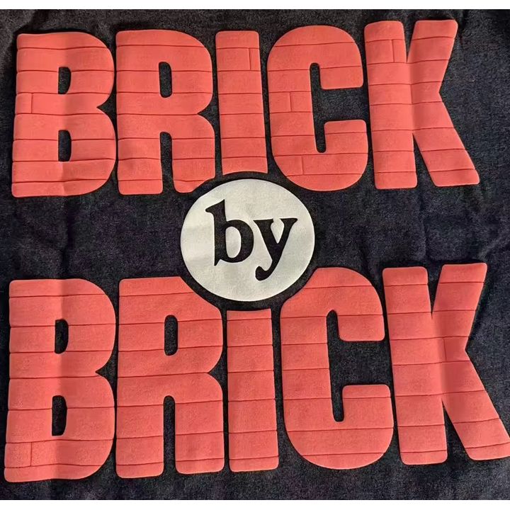 BRICK-by-BRICK – Built Not Given Tee
